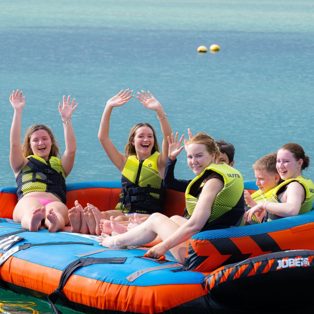 a group of people on a raft in a body of water